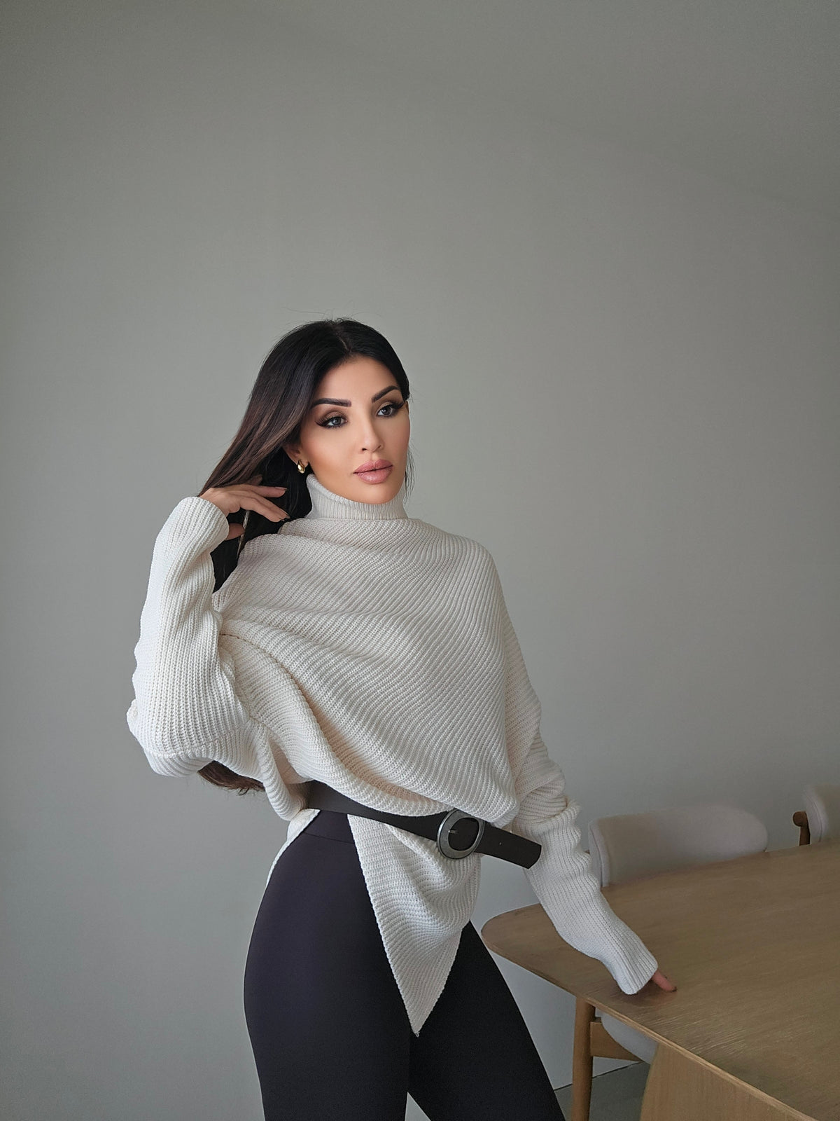 Off-white asymmetric ribbed turtleneck sweater with a black faux leather belt