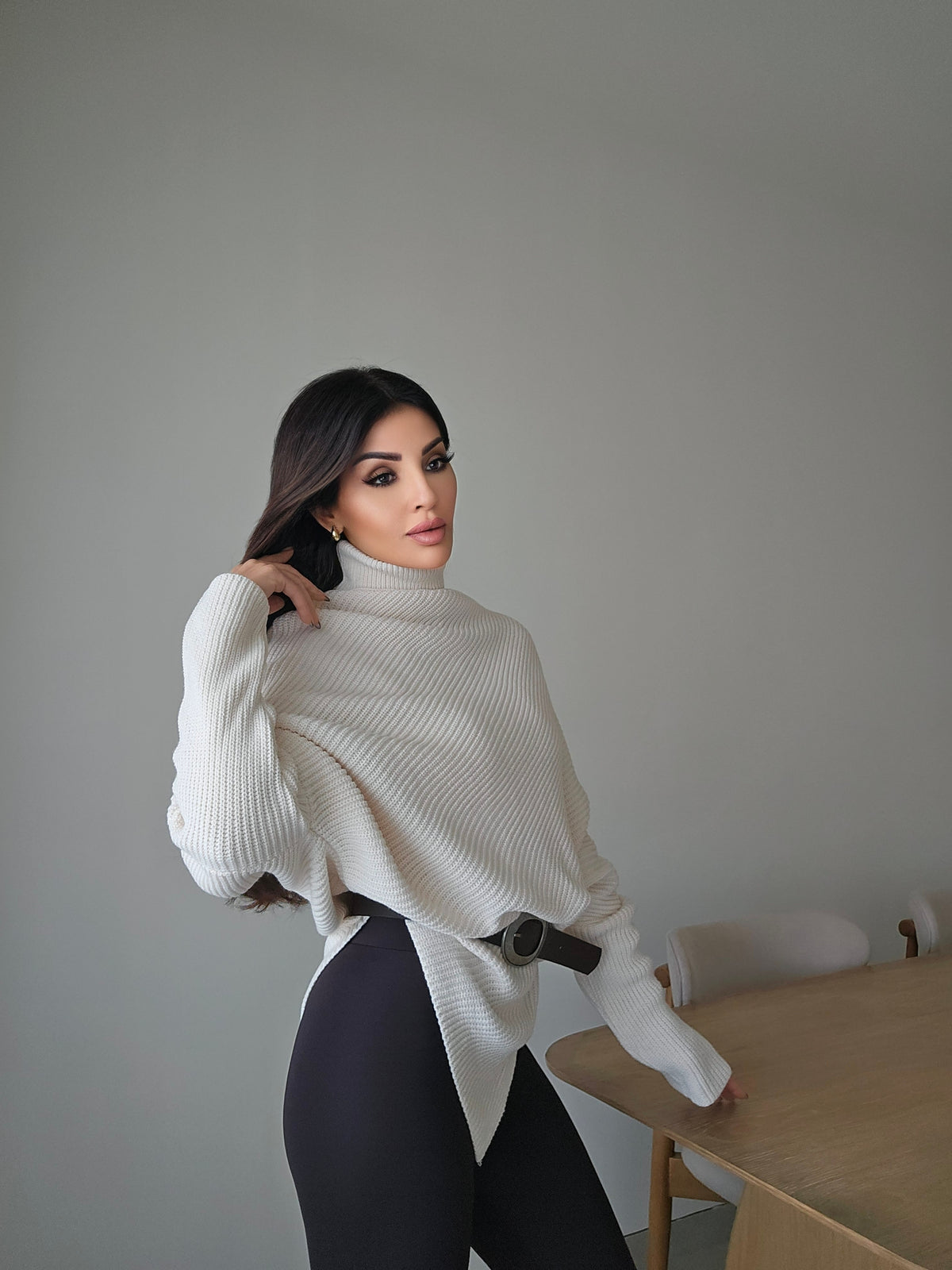 Off-white asymmetric ribbed turtleneck sweater with a black faux leather belt