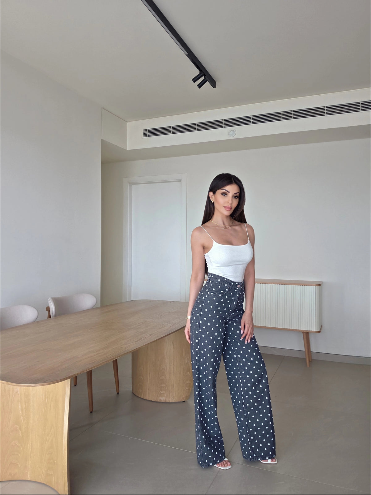 high-waisted dark grey and white polka dot wide-leg pants